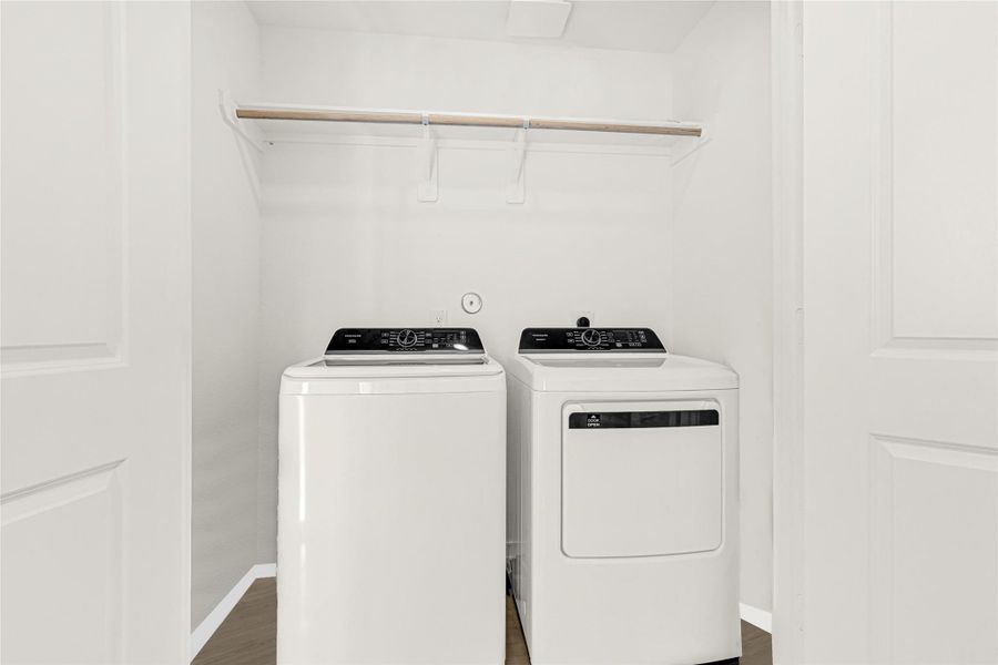 This photo shows a compact laundry space with a modern washer and dryer set, located inside of the home. This photo shows a compact laundry space with a modern washer and dryer set, located inside of the home.