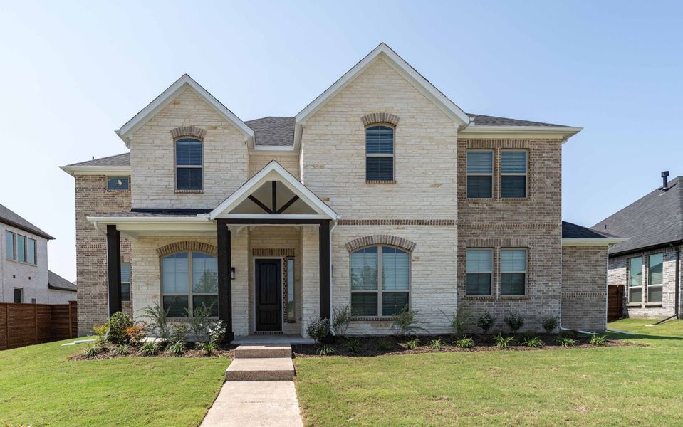 Front exterior of a new home in Solterra, Mesquite, TX, highlighting curb appeal (Image 1).