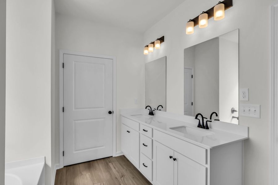 Primary en suite bathroom with double vanities!