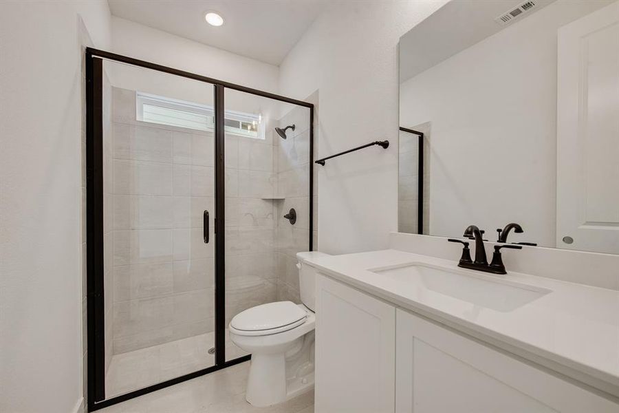 Bathroom with vanity, a shower stall, and recessed lighting Bathroom with vanity, a shower stall, and recessed lighting