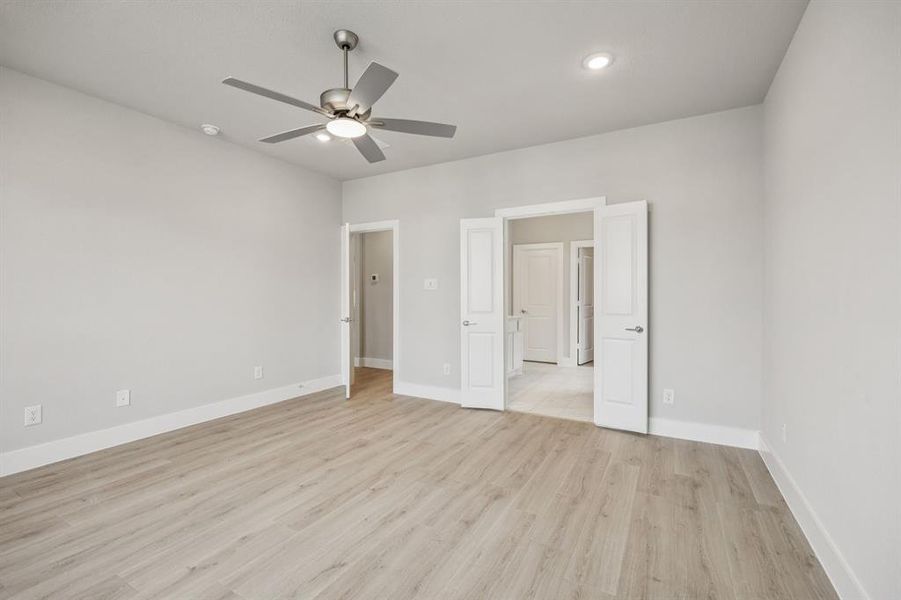 Unfurnished bedroom with light wood-style flooring and ceiling fan Unfurnished bedroom with light wood-style flooring and ceiling fan