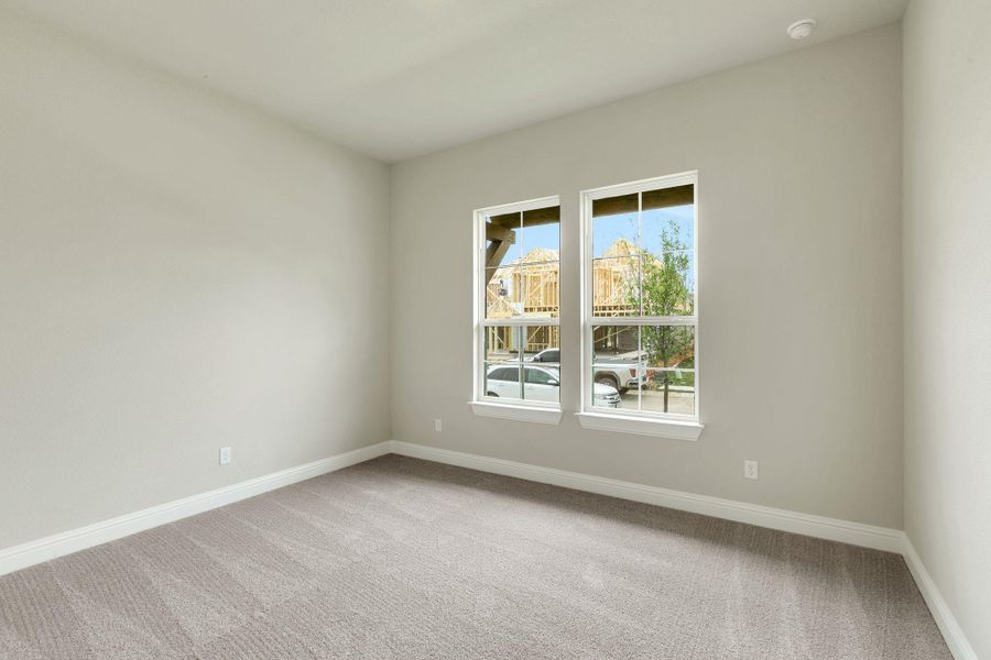 Unfurnished room with carpet and baseboards Unfurnished room with carpet and baseboards