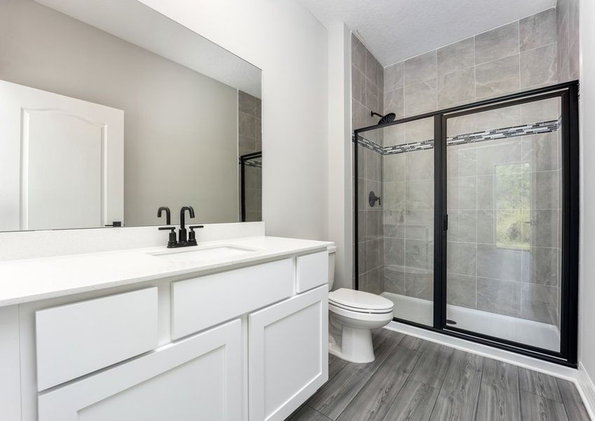 The master bathroom has a large vanity and step-in shower