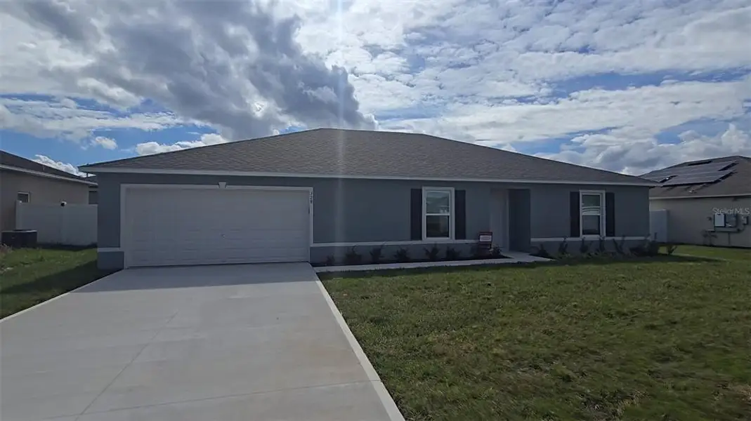 Front exterior of a new home in , Poinciana, FL, highlighting curb appeal (Image 2). Front exterior of a new home in , Poinciana, FL, highlighting curb appeal (Image 2).