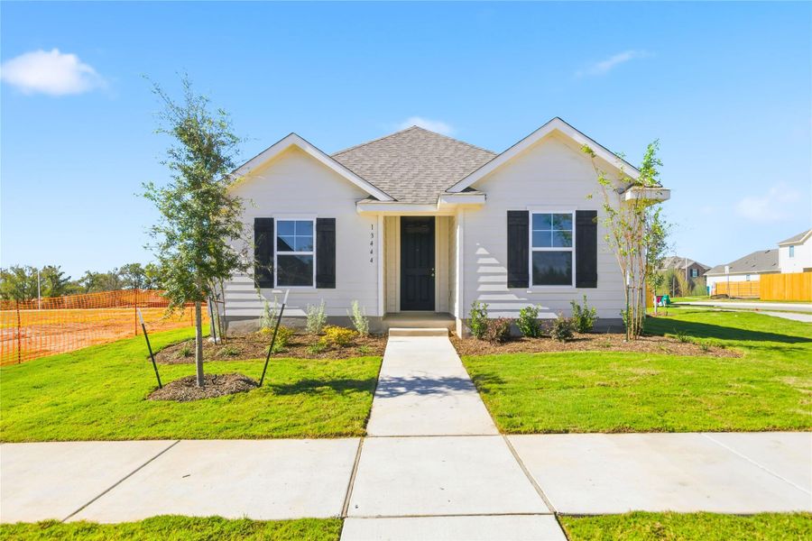 View of front of home featuring a shingled roof