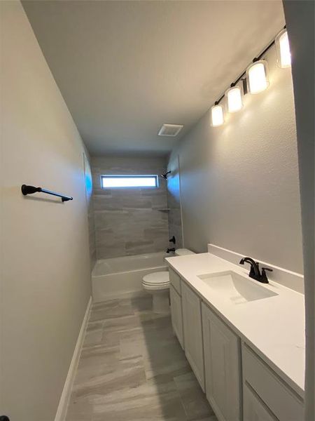 Bath 3 with window for natural light, quartz counters & 12x24 tile (mirror not installed yet)