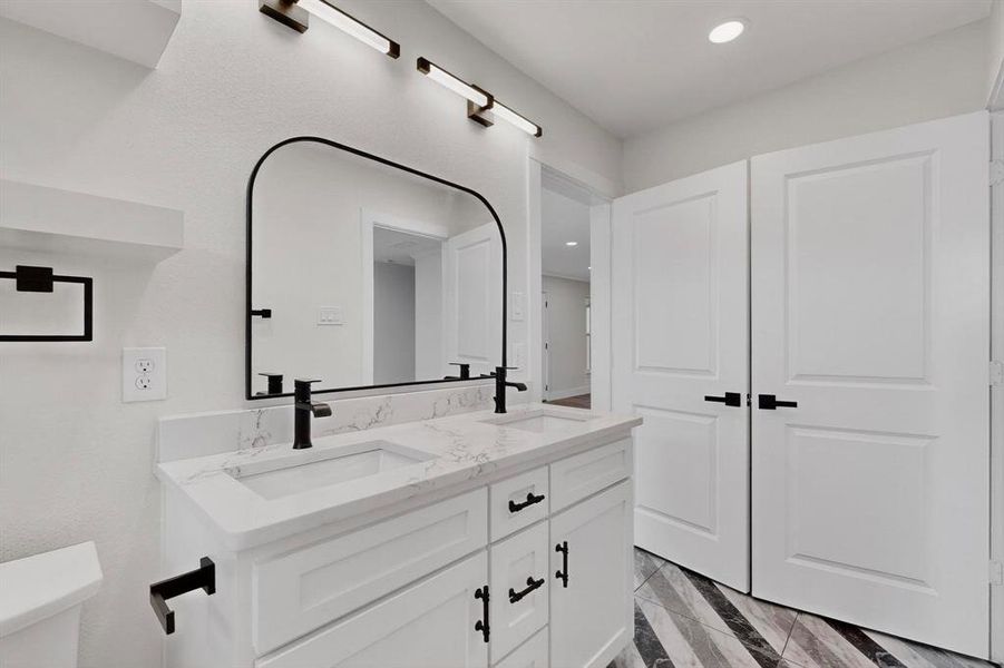 Full bath featuring double vanity and recessed lighting
