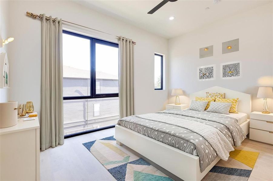 Bedroom featuring ceiling fan and light hardwood / wood-style flooring