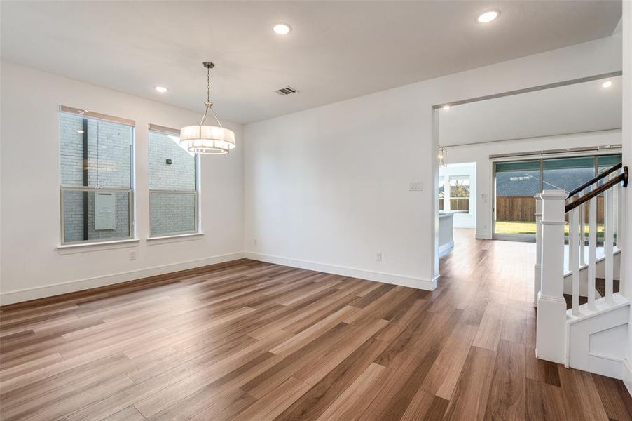 Formal diningroom featuring recessed lighting, light wood-type flooring, and stairway Formal diningroom featuring recessed lighting, light wood-type flooring, and stairway