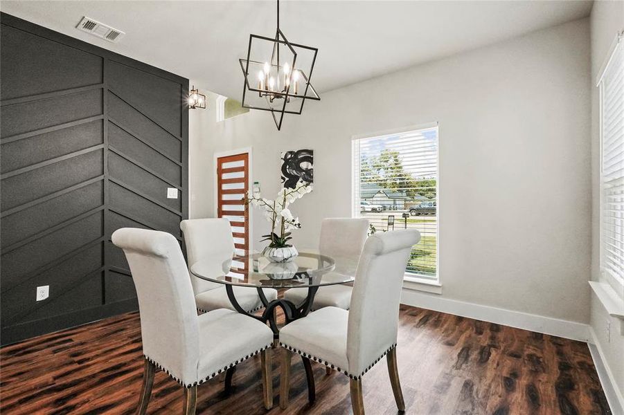Dining space featuring dark wood-style floors and a chandelier Dining space featuring dark wood-style floors and a chandelier