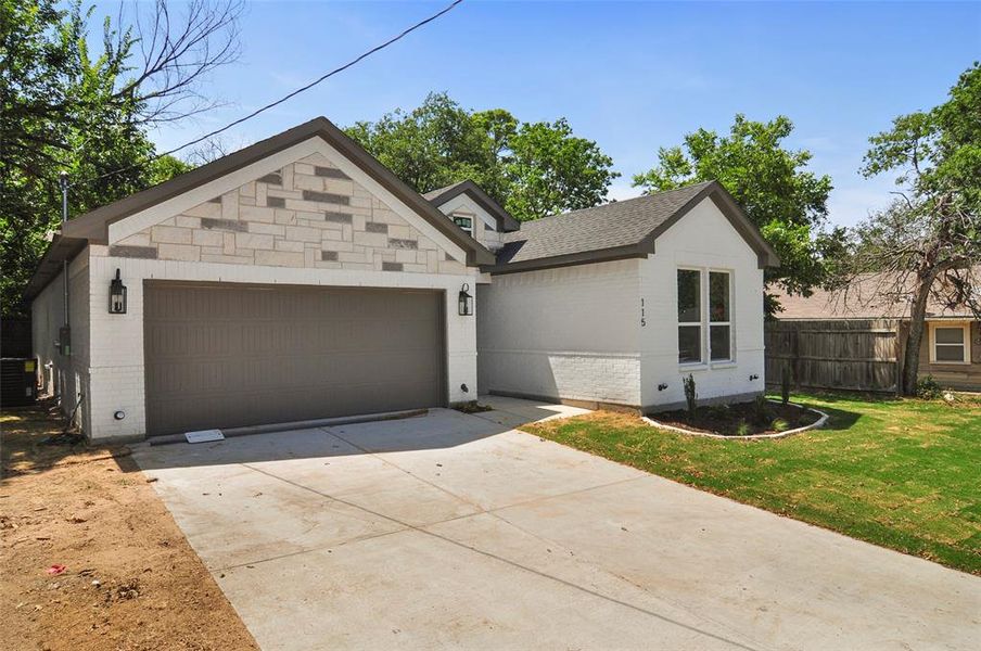 View of front of house with a garage, a front lawn, and central AC unit