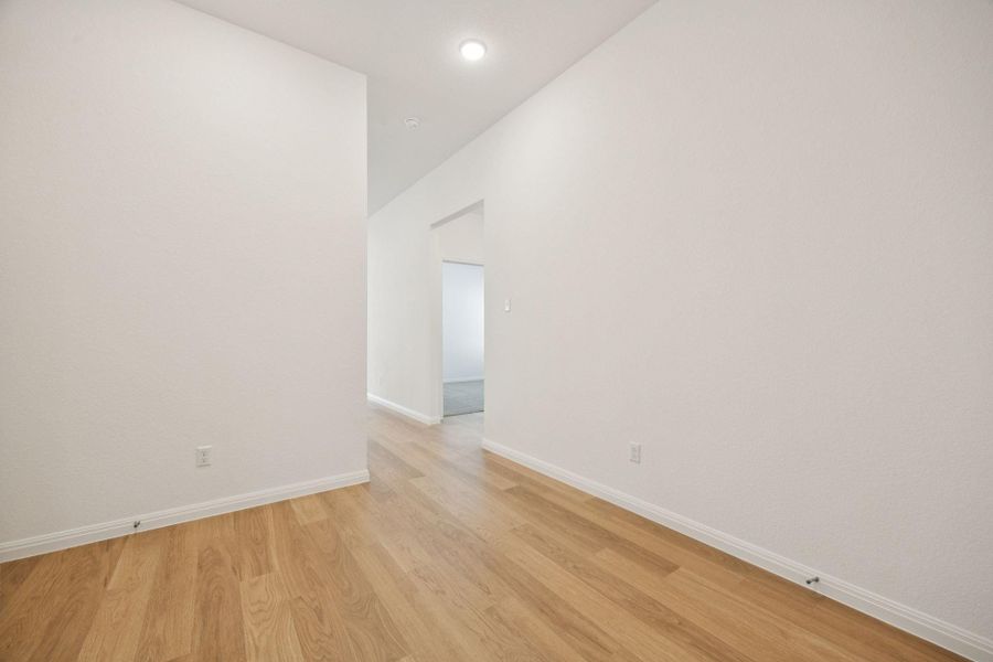 Spare room featuring light wood finished floors and baseboards