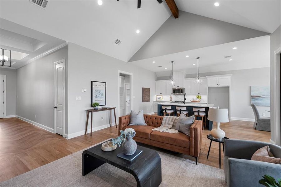 Living room featuring beamed ceiling, parquet flooring, high vaulted ceiling, recessed lighting, and a chandelier Living room featuring beamed ceiling, parquet flooring, high vaulted ceiling, recessed lighting, and a chandelier
