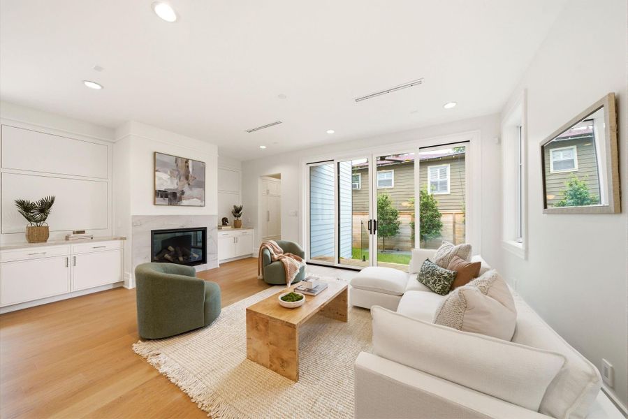 Bright and inviting family room featuring custom built-ins, contemporary fireplace, and seamless indoor-outdoor flow. Bright and inviting family room featuring custom built-ins, contemporary fireplace, and seamless indoor-outdoor flow.