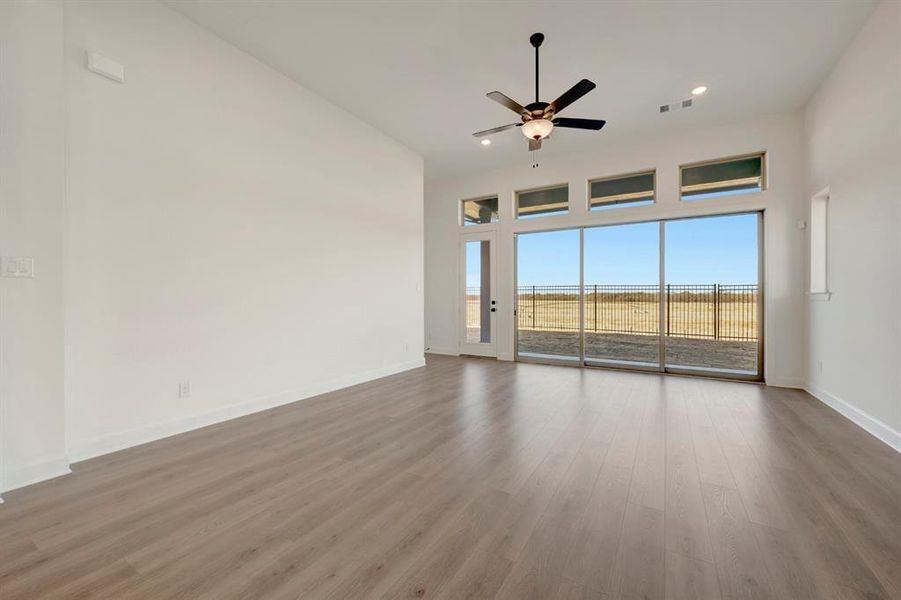 Empty room with a ceiling fan, wood finished floors, and recessed lighting Empty room with a ceiling fan, wood finished floors, and recessed lighting