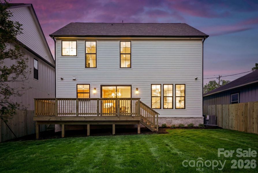 Rear view at twilight. Note: The lawn has been recently seeded, and photography has been digitally enhanced to represent the yard at full, established growth. Rear view at twilight. Note: The lawn has been recently seeded, and photography has been digitally enhanced to represent the yard at full, established growth.