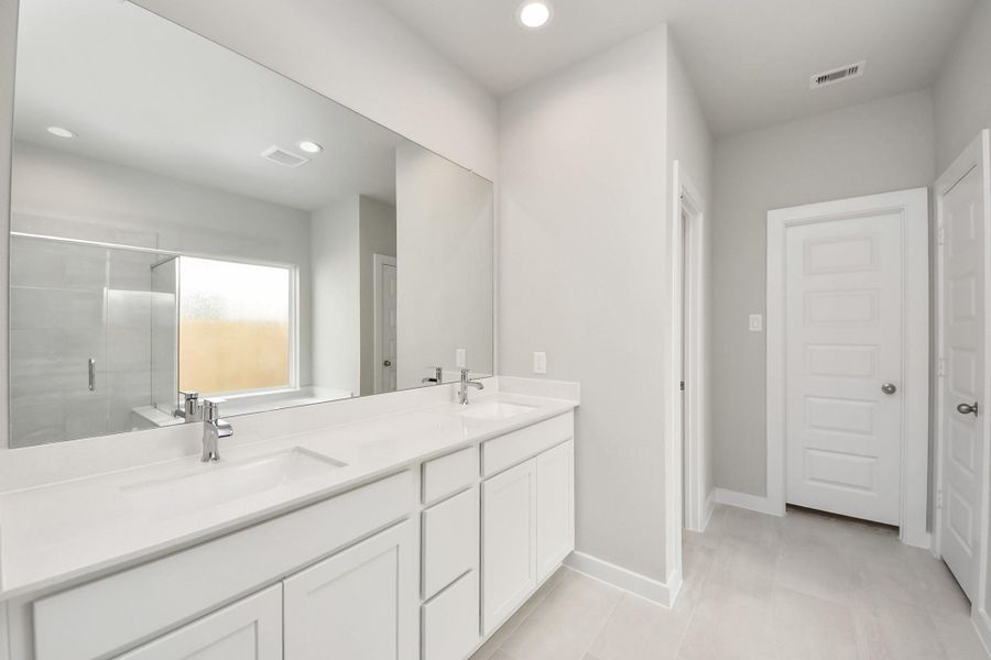 Indulge in a spa-like retreat within the confines of this primary bathroom. Delight in a spacious walk-in shower enveloped in stylish tile surround, unwind in a separate garden tub adorned with custom detailing, and elevate your daily routine at the elegant vanity, now equipped with double sinks, light countertops, modern hardware, and beautiful recessed lights. Indulge in a spa-like retreat within the confines of this primary bathroom. Delight in a spacious walk-in shower enveloped in stylish tile surround, unwind in a separate garden tub adorned with custom detailing, and elevate your daily routine at the elegant vanity, now equipped with double sinks, light countertops, modern hardware, and beautiful recessed lights.