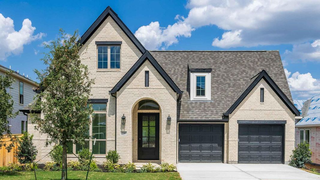 View of front of home with concrete driveway, a shingled roof, a garage, and brick siding View of front of home with concrete driveway, a shingled roof, a garage, and brick siding