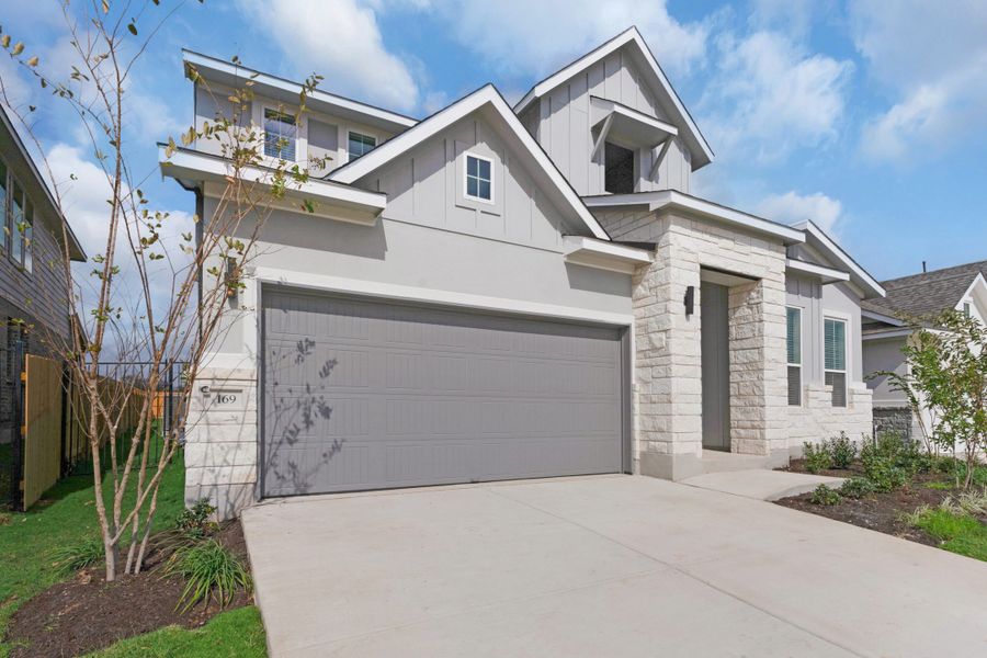 Front exterior of a new home in Santa Rita Ranch, Liberty Hill, TX, highlighting curb appeal (Image 11). Front exterior of a new home in Santa Rita Ranch, Liberty Hill, TX, highlighting curb appeal (Image 11).
