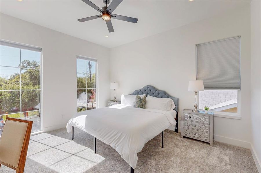 Carpeted bedroom with ceiling fan