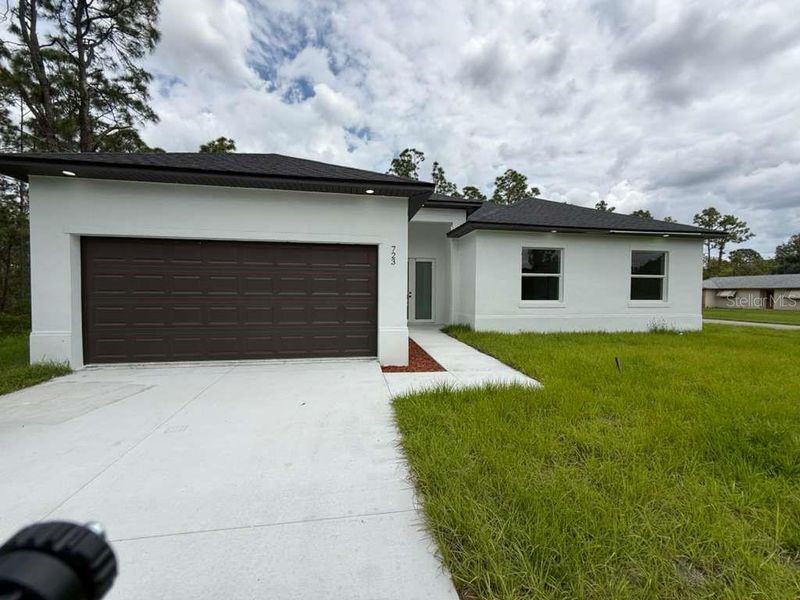 Front exterior of a new home in , Lehigh Acres, FL, highlighting curb appeal (Image 20). Front exterior of a new home in , Lehigh Acres, FL, highlighting curb appeal (Image 20).