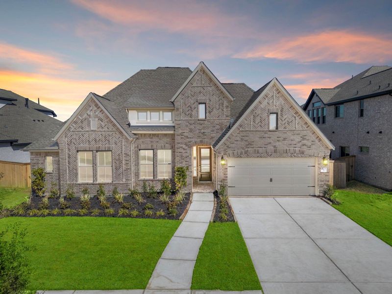 Front exterior of a new home in Valencia 70', Manvel, TX, highlighting curb appeal (Image 1).