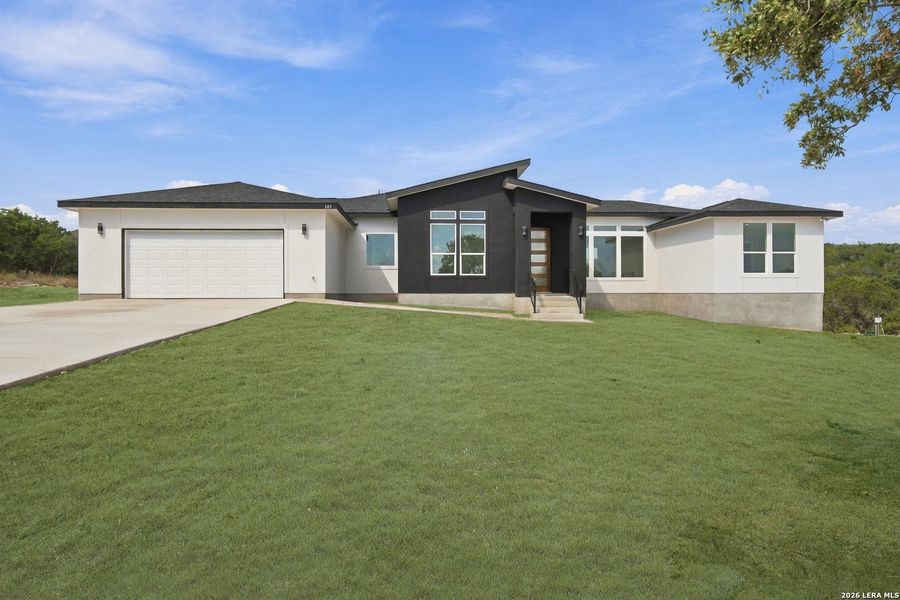 Front exterior of a new home in , Mico, TX, highlighting curb appeal (Image 24).