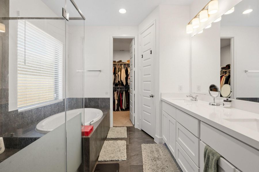 Luxurious primary bath with dual vanities and ample storage