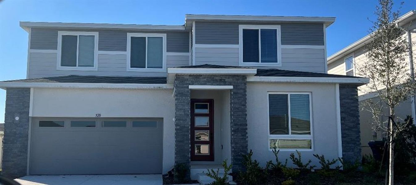 Front exterior of a new home in Seasons at Eden Hills, Lake Alfred, FL, highlighting curb appeal (Image 23).
