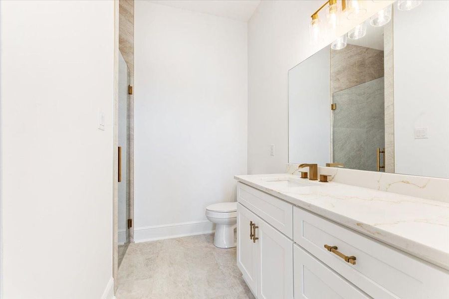 Additional view of the bathroom featuring modern finishes and generous vanity space. Additional view of the bathroom featuring modern finishes and generous vanity space.
