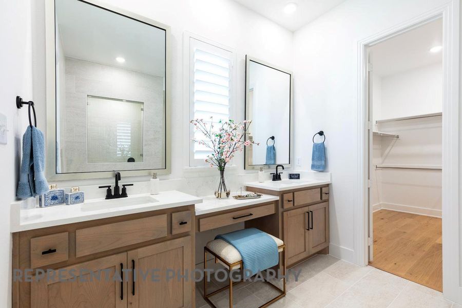 Full bathroom with vanity, a walk in closet, and tile patterned floors Full bathroom with vanity, a walk in closet, and tile patterned floors