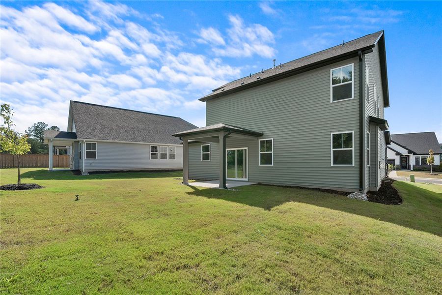 A spacious grassy lawn stretches behind the classi