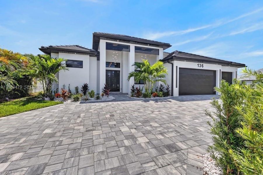 Front exterior of a new home in , Cape Coral, FL, highlighting curb appeal (Image 25). Front exterior of a new home in , Cape Coral, FL, highlighting curb appeal (Image 25).