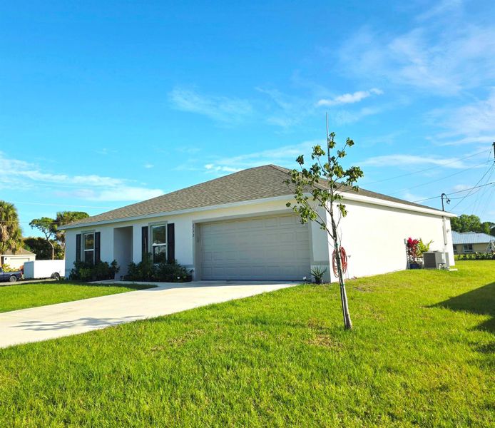Front exterior of a new home in , Port St. Lucie, FL, highlighting curb appeal (Image 6).