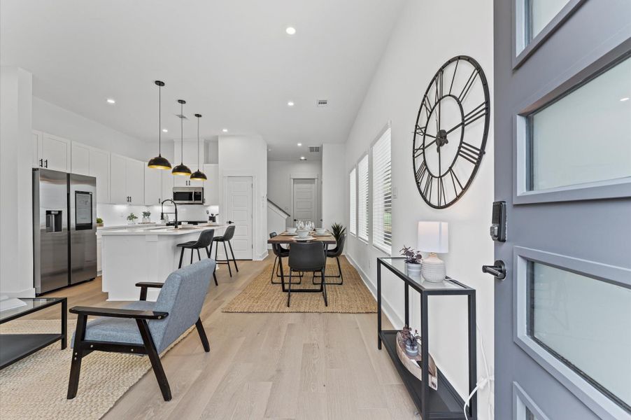 This inviting home features a spacious open-concept layout on the first floor, seamlessly connecting the living, dining, and kitchen areas to create a warm and functional gathering space. Large windows and glass door direct access to the front yard flooding the interior with natural light and extending the living space outdoors, perfect for entertaining or relaxing in the fresh air. The thoughtful design balances comfort and flow, making everyday living feel effortlessly connected to nature.