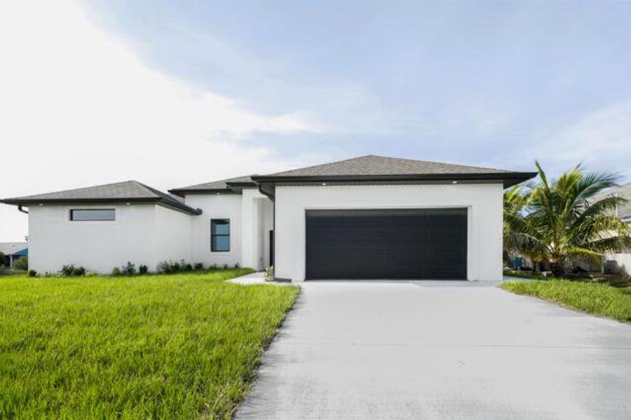 Front exterior of a new home in , Cape Coral, FL, highlighting curb appeal (Image 1). Front exterior of a new home in , Cape Coral, FL, highlighting curb appeal (Image 1).
