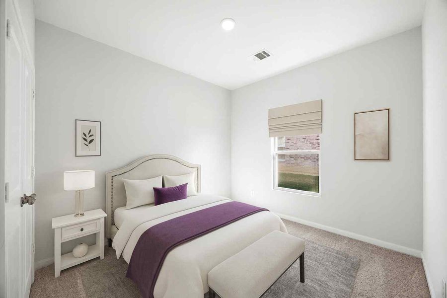 A bedroom with a bed and a lamp.