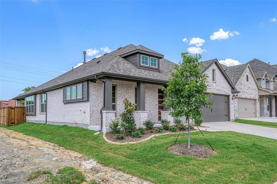 View of front of home with a front yard, brick siding, and a shingled roof View of front of home with a front yard, brick siding, and a shingled roof