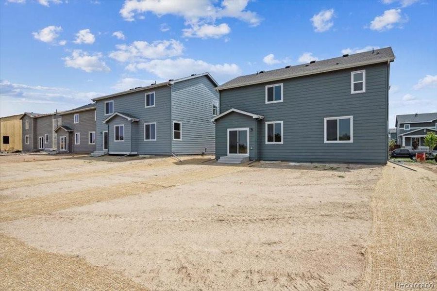 Front exterior of a new home in Farmlore, Brighton, CO, highlighting curb appeal (Image 2).