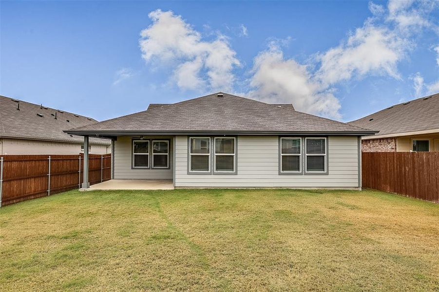 Rear view of house with a patio area, a fenced backyard, and roof with shingles Rear view of house with a patio area, a fenced backyard, and roof with shingles