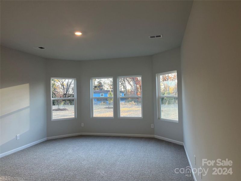 The Primary bedroom features a bay window