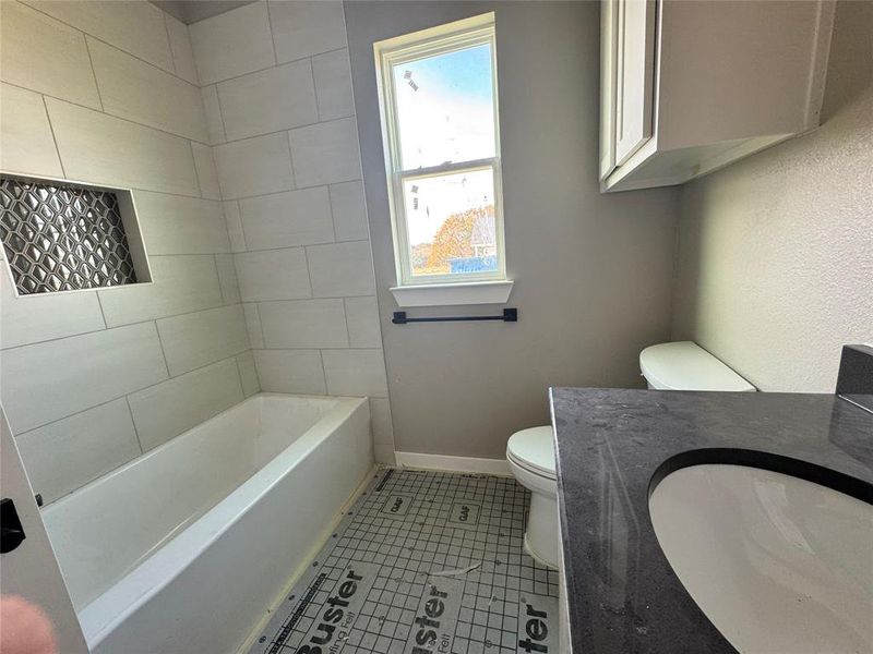 Bathroom featuring tile patterned floors, vanity, and toilet