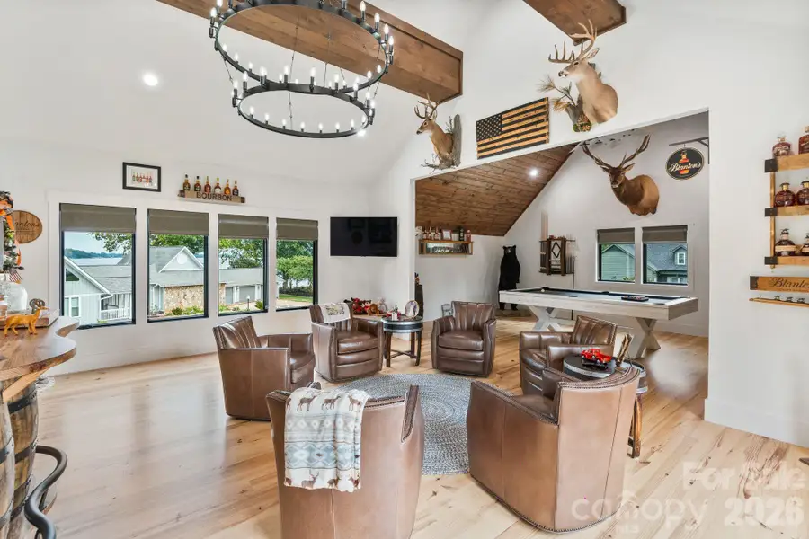 Dedicated bonus room features rustic industrial lighting and private entrance from the garage Dedicated bonus room features rustic industrial lighting and private entrance from the garage