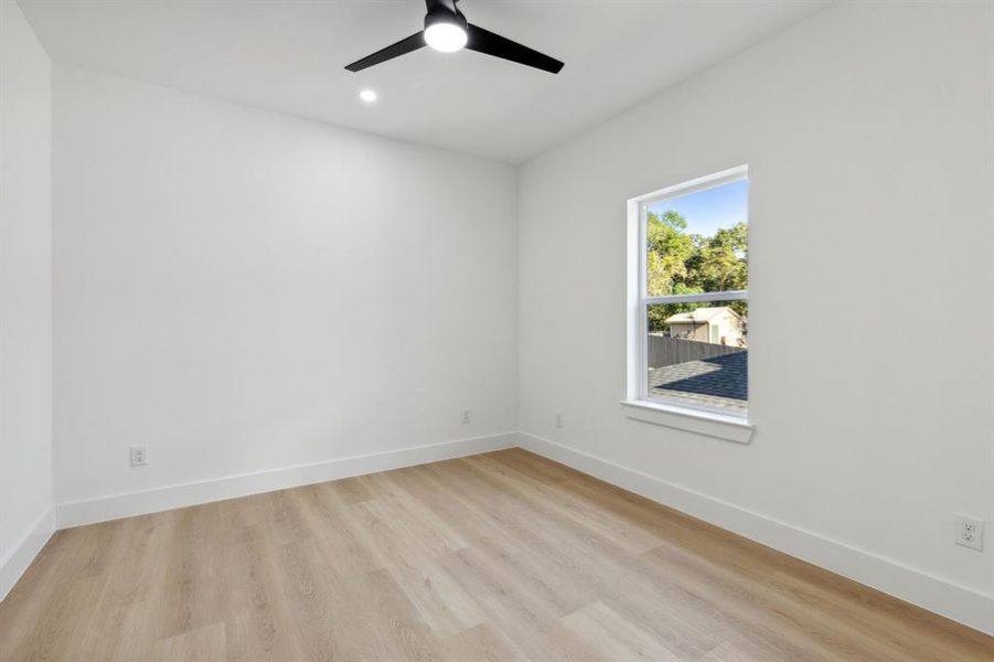 Empty room featuring ceiling fan and light hardwood / wood-style flooring