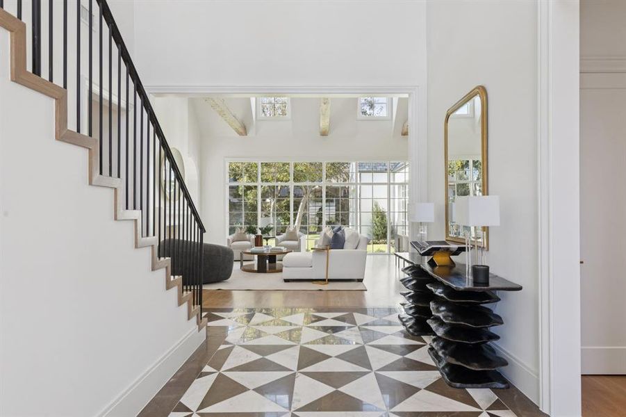 Foyer entrance featuring a high ceiling and stairway