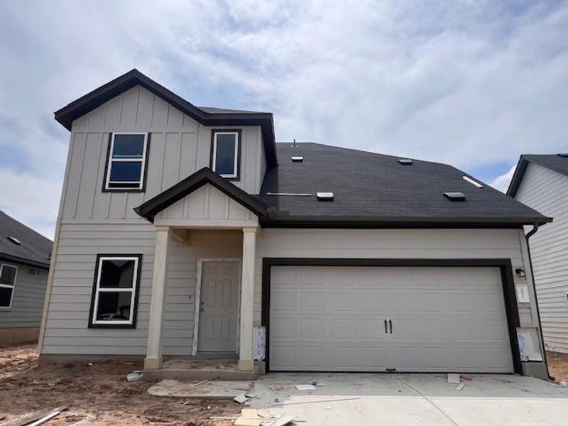 Front exterior of a new home in Cascades at Onion Creek, Austin, TX, highlighting curb appeal (Image 2). Front exterior of a new home in Cascades at Onion Creek, Austin, TX, highlighting curb appeal (Image 2).