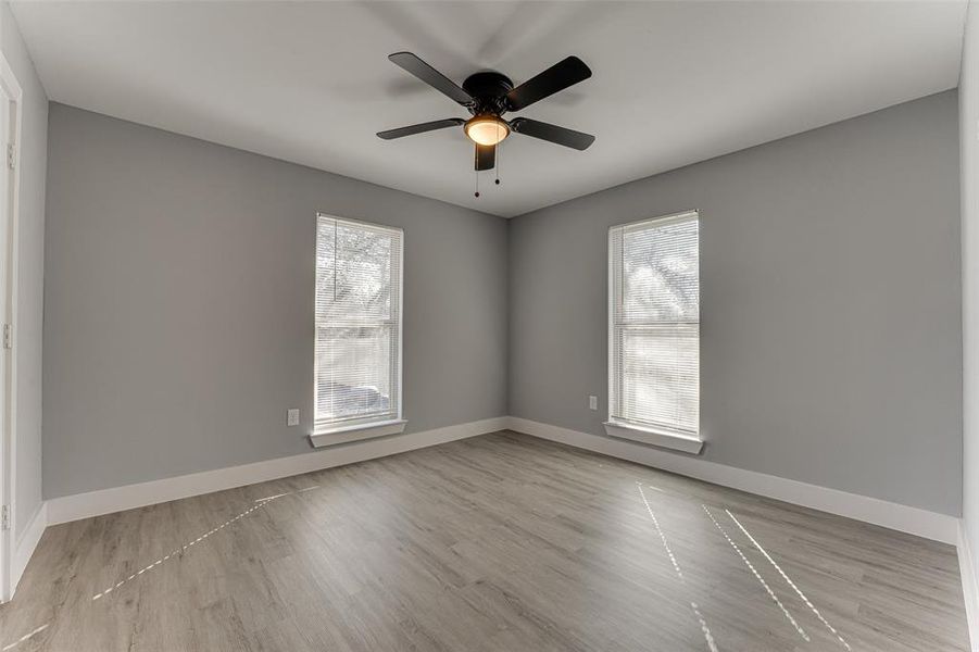 Spare room featuring ceiling fan and light wood-type flooring