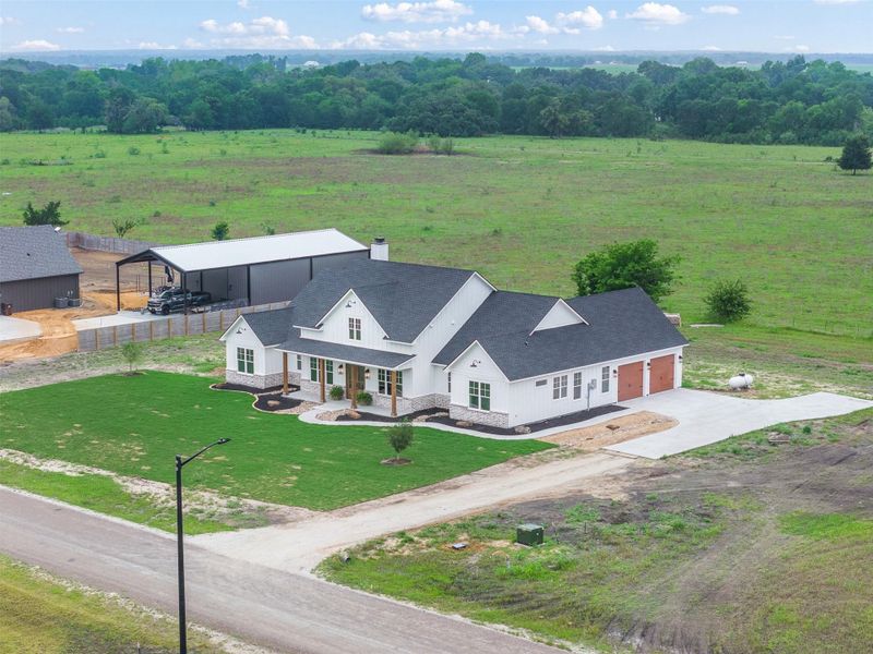 Front exterior of a new home in , Snook, TX, highlighting curb appeal (Image 29).