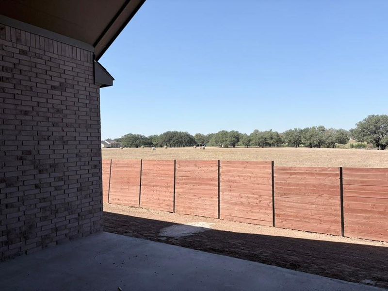 View of yard with a patio area and a view of rural / pastoral area