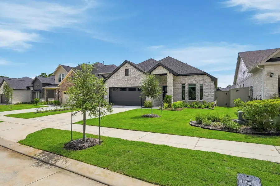 Front exterior of a new home in Audubon, Magnolia, TX, highlighting curb appeal (Image 2). Front exterior of a new home in Audubon, Magnolia, TX, highlighting curb appeal (Image 2).